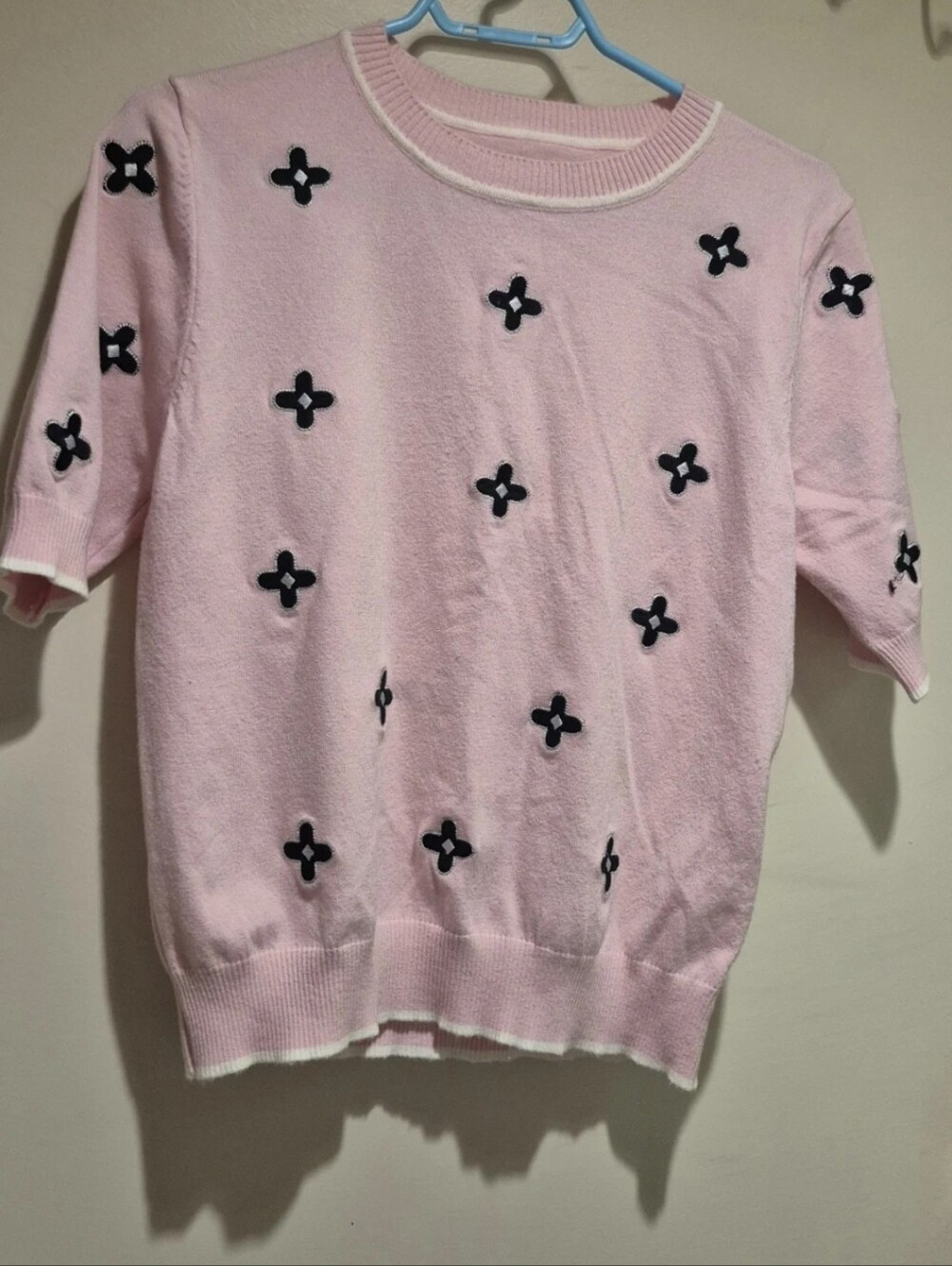 Pink Sweater With Black Flower Embellishments